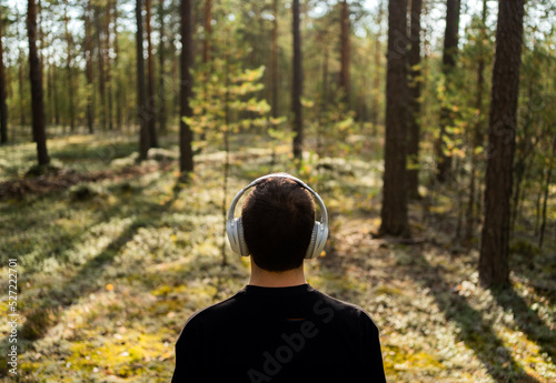 A man meditates listening to calm music with headphones harmony with nature #527222701