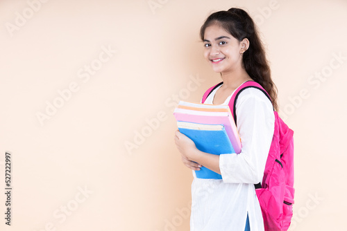 Photography Smiling portrait of Girl with holding books in hand
