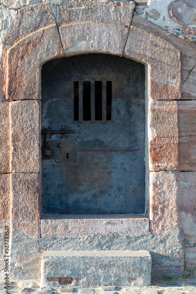 Old metal security door with bars in Montjuic castle