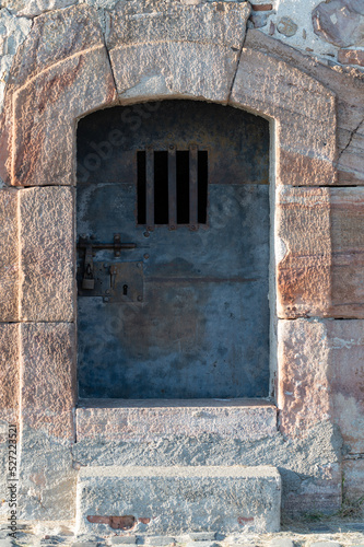 Old metal security door with bars in Montjuic castle © Adolf