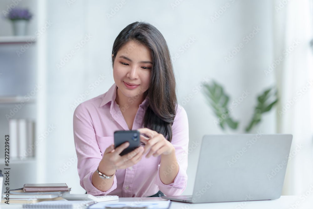 Asian business women are enjoying using smartphone and social media application with pleasure and pleasure at the office. Asian business women are enjoying using smartphone and social media application with pleasure and pleasure at the office.