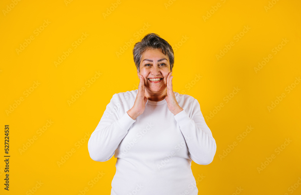 hispanic matured woman portrait on yellow background in Mexico Latin America hispanic matured woman portrait on yellow background in Mexico Latin America