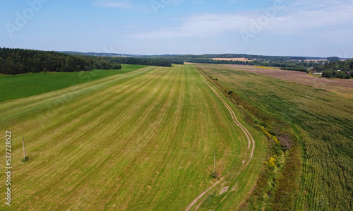 Aerial view of agro rural fields. Harvesting on the farm landscape