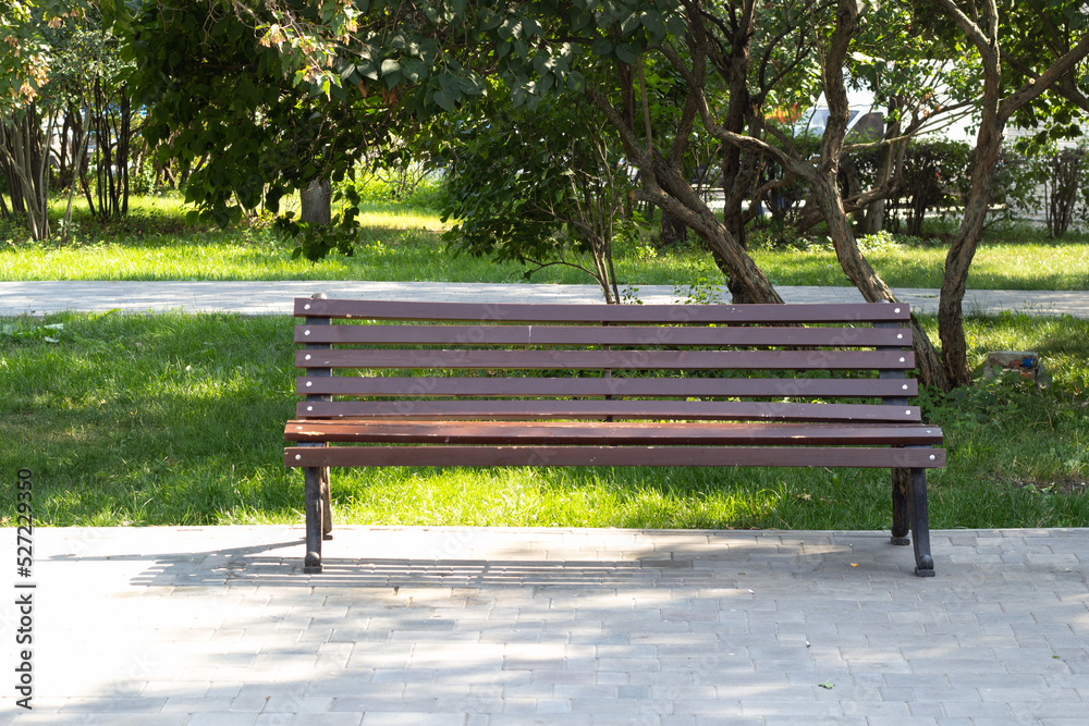 Wooden alone bench in the park against . Wooden alone bench in the park against .