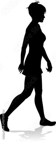 A silhouette woman in profile walking wearing a dress photo