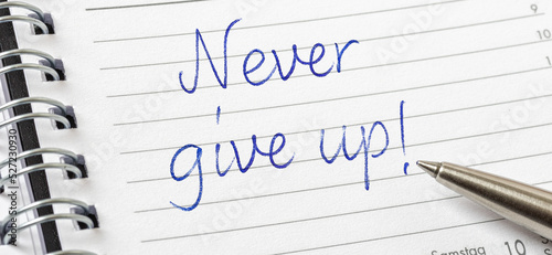 Never give up written on a calendar page