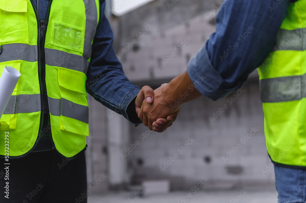 Close-up hand of Civil Engineer with contractor partners are shaking their hands in construction building, agreement of partners in contract. Handshake of civil engineer business concept. Close-up hand of Civil Engineer with contractor partners are shaking their hands in construction building, agreement of partners in contract. Handshake of civil engineer business concept.