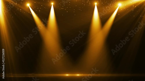 The spotlight illuminates the stage background