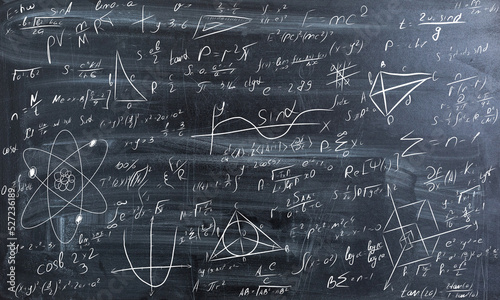 Blackboard inscribed with scientific formulas and calculations in physics and mathematics. 