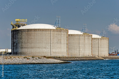 Rotterdam, The Netherlands, August 23, 2022: three large concrete oil tanks on a sunny day at Maasvlakte industrial area photo