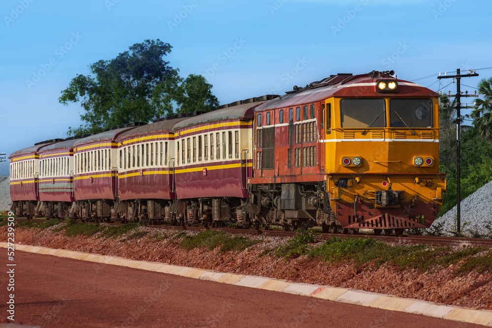 Passenger train by diesel locomotive on the railway.