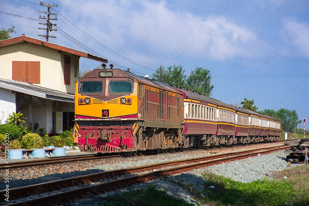 Passenger train by diesel locomotive was arriving the station. (building is public) Passenger train by diesel locomotive was arriving the station. (building is public)