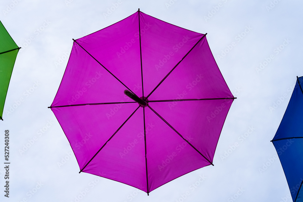 UMBRELLA - Colorful objects on the background of the clouds sky
