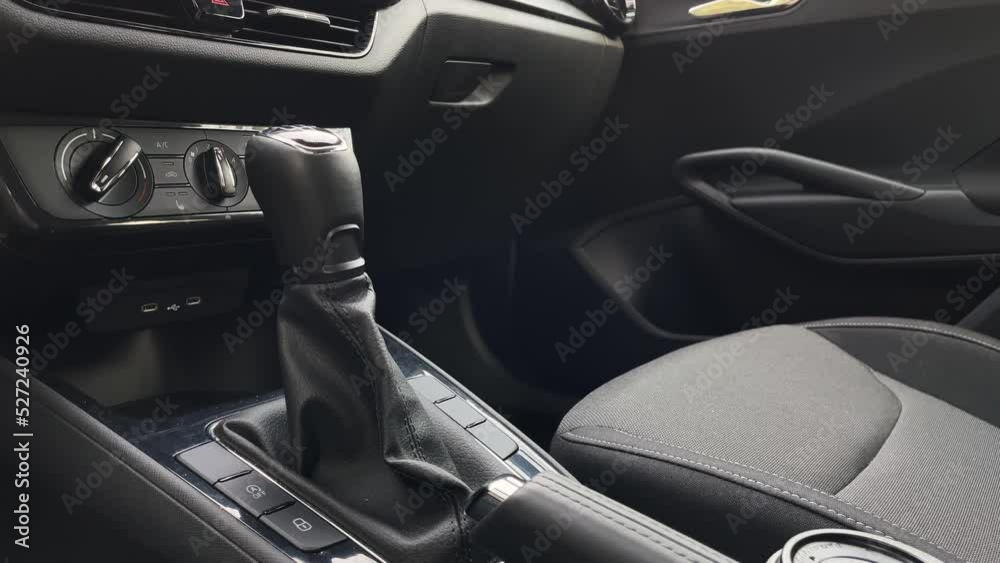 Release of hand or parking brake and shifting first gear, car interior low angle close up view Release of hand or parking brake and shifting first gear, car interior low angle close up view