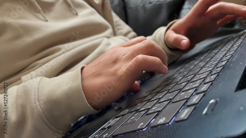 Pressing backspace on laptop keyboard, closeup view of fingers and hands, correcting typing photo