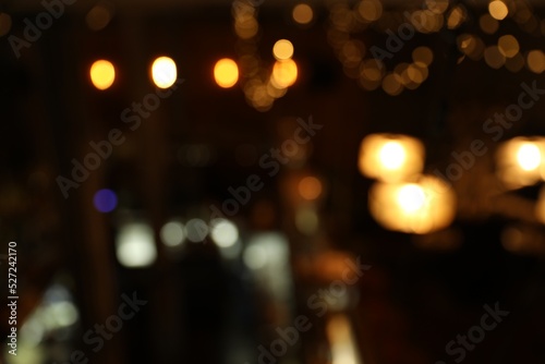 Blurred view of stylish modern bar interior with bokeh effect