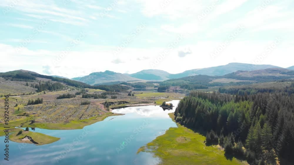 Mountainous lake landscape in Scotland on sunny day, drone shot. Mountainous lake landscape in Scotland on sunny day, drone shot.