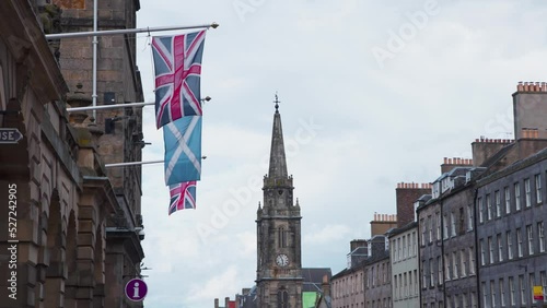 British and Scottish flags on facade flagpoles, Royal Mile, Edinburgh. photo