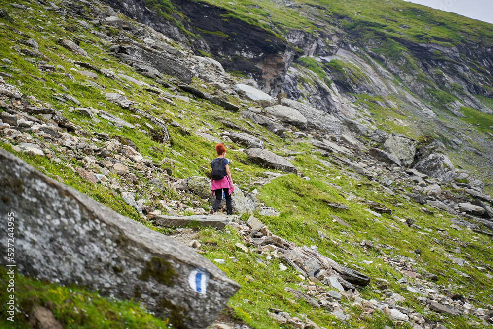 Woman hiker on a trail in the mountains