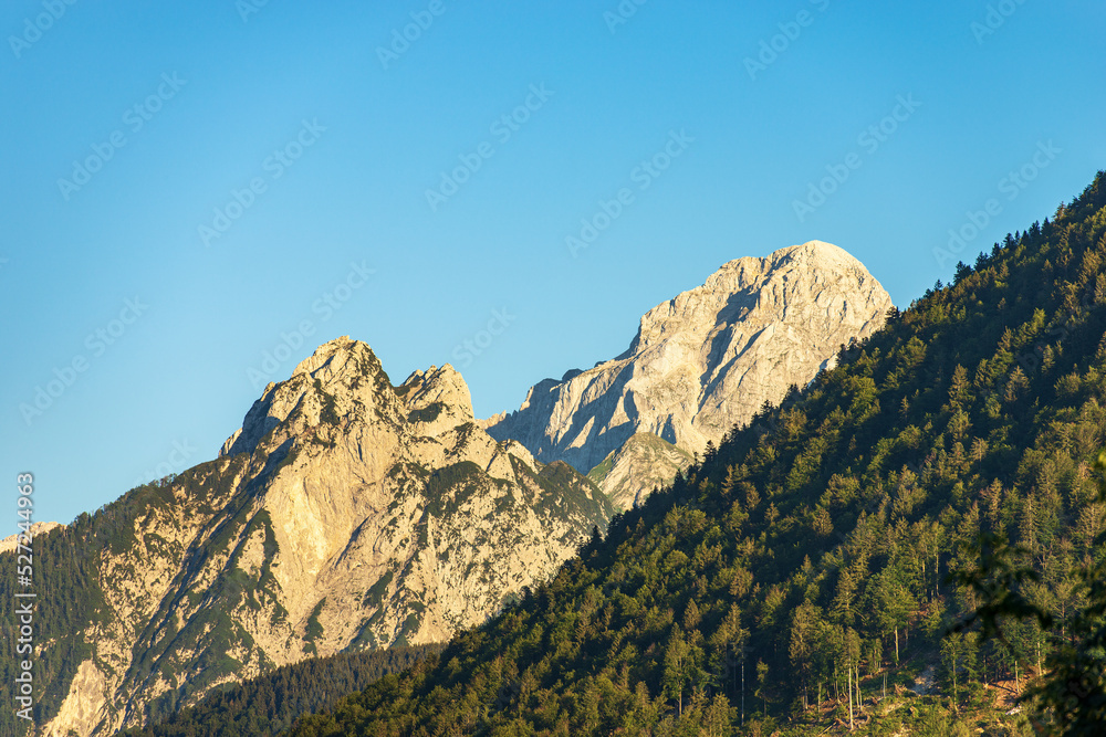 Mountain Range and the peak of the Mount Mangart (2677 m.) seen from the small village of Camporosso in Valcanale, Julian Alps, Tarvisio, Udine, Friuli Venezia Giulia, Italy Slovenia border, Europe.