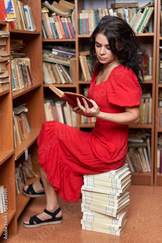 Woman in red dress in a library