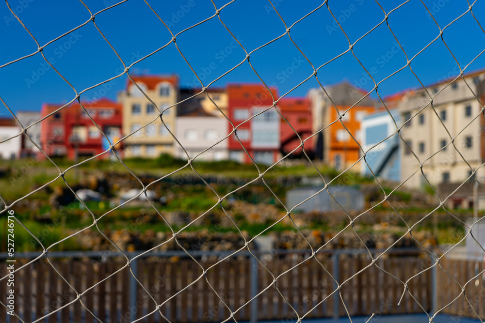 Fototapeta premium some houses behind a fence