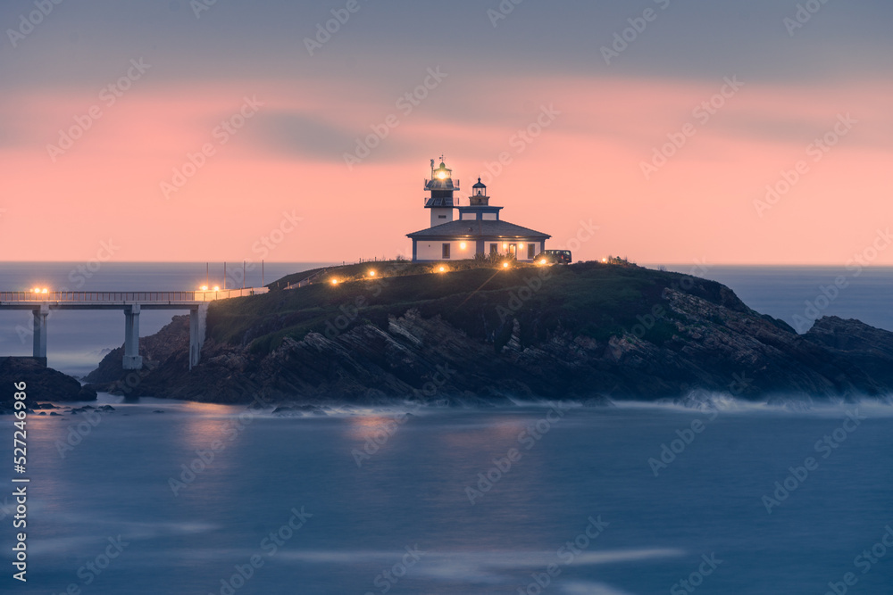 lighthouse at sunset on an island