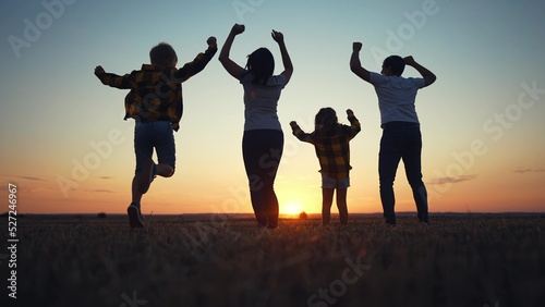 friendly family jumping rejoice. silhouette a happy family bouncing with happiness after victory in nature sunset. happy family kid dream freedom concept. big family happy freedom in nature lifestyle