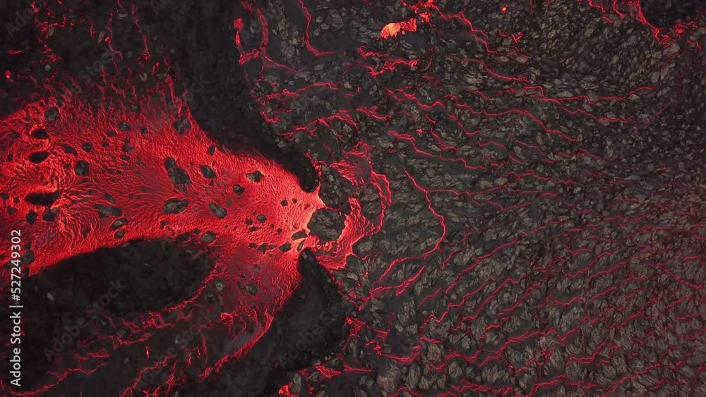 Aerial rising top view of a lava river flowing across Meradalir valley, Iceland, erupting out of Fagradalsfjall volcano