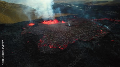 Aerial panoramic view of magma and lava erupting in Meradalir valley, from Fagradalsfjall volcano, with smoke coming out photo