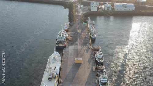 Sandgerði fishing boats anchored at dock during bright sunrise, aerial photo