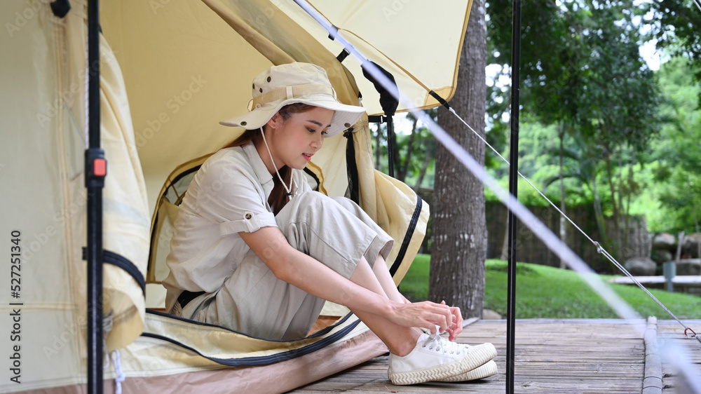 Happy young asian female traveler camping in nature park on beautiful day. Travel, adventure and vacation concept Happy young asian female traveler camping in nature park on beautiful day. Travel, adventure and vacation concept