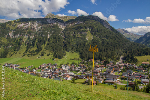 View of austrian village Lech am Arlberg at the European Alps with surrounding mountains, during summer photo