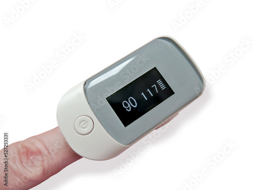 Finger with a pulse oximeter on a white background close-up. Display shows low saturation. Medicine, covid-19, symptoms, diagnostics, measuring instruments, oxygen saturation sensor