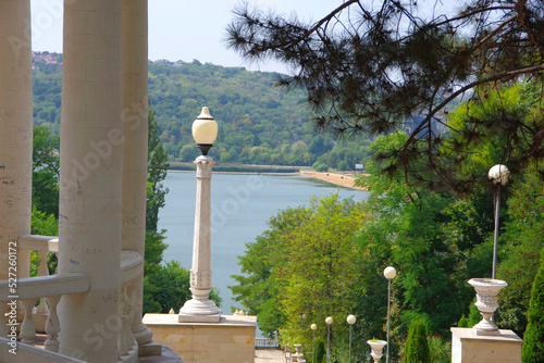 Moldova. Kishinev. 08.28.2022. Arbor with white columns and a view of the lake. Park Valea Morilor.