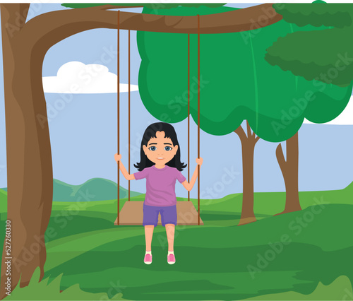 girl child swings on swing in tree