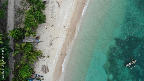 Aerial view of the turquoise bay with boats. Baucau, East Timor. photo