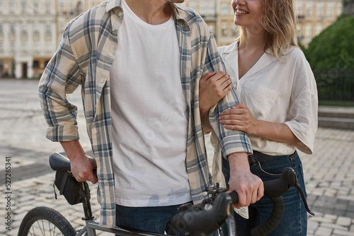 Partial of couple in love with bicycle resting