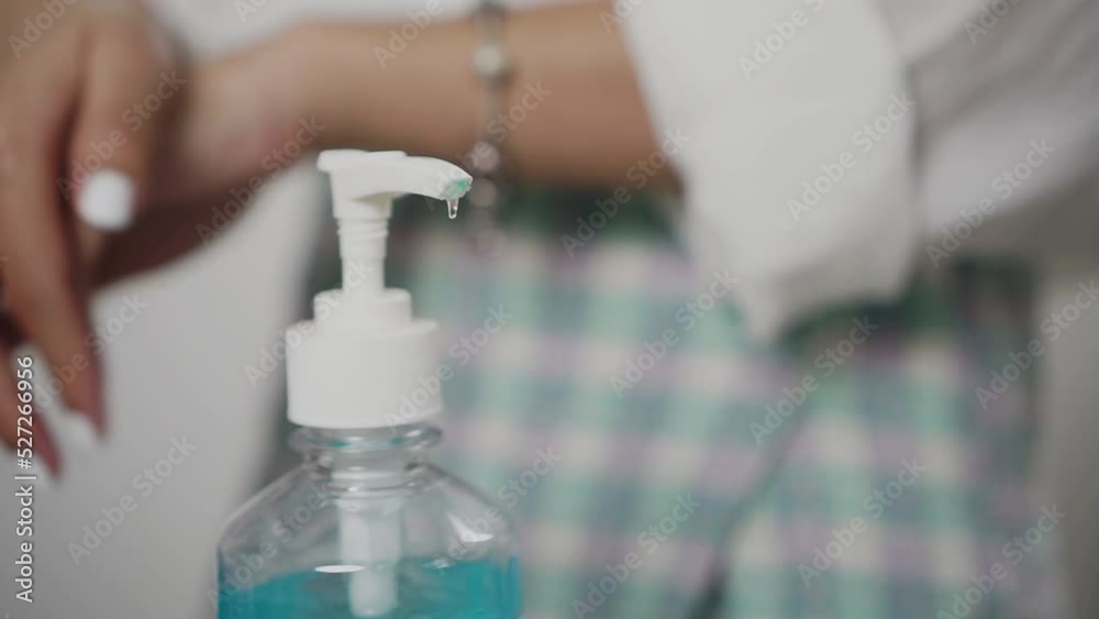 close-up woman hands using sanitizer to disinfect her hands close-up woman hands using sanitizer to disinfect her hands