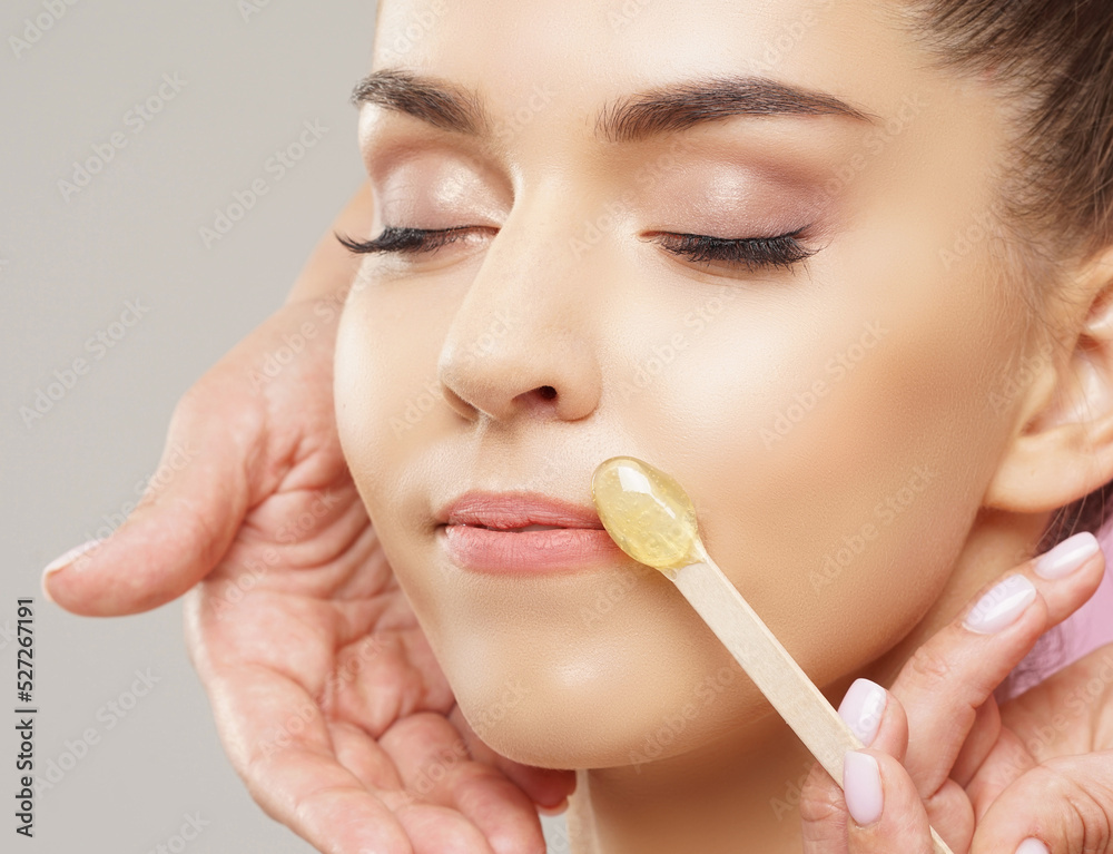 Hair removal, beauty and health concept. A young girl is getting an