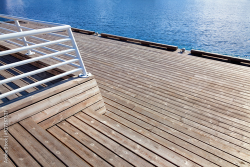 Dock with clapboards floor. Walkway at harbord