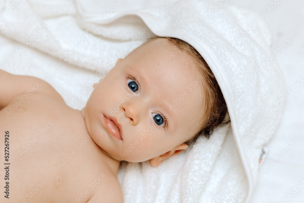 Portrait of a baby, Happy smiling baby in a towel after bathing Portrait of a baby, Happy smiling baby in a towel after bathing