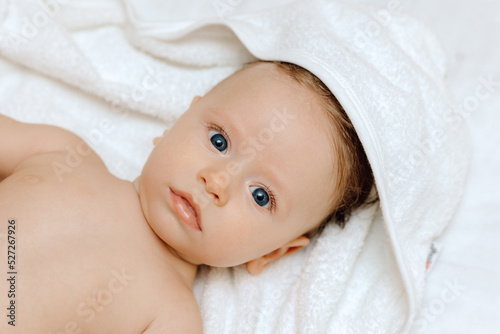 Portrait of a baby, Happy smiling baby in a towel after bathing 
