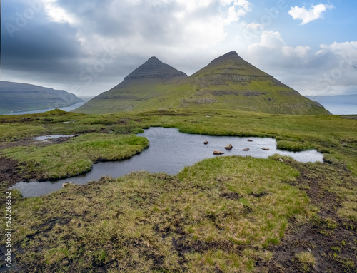 Hiking to the top of the Klakkur mountain near Klaksvík, the second largest town of the Faroes behind Tórshavn, located on Borðoy Island, Norðoyar, Faroe Islands photo