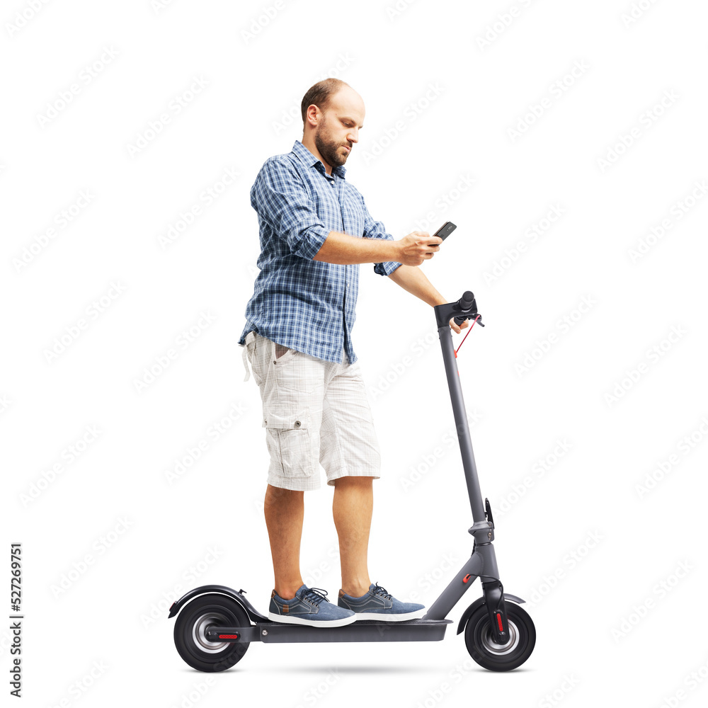 Man using a smartphone while riding an electric scooter