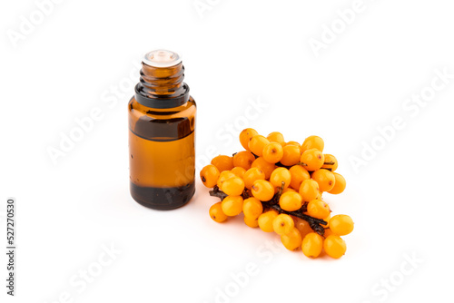 Sea-buckthorn oil and berries on a white background.