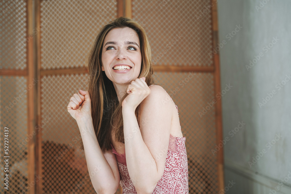 Fototapeta premium Emotional portrait of young woman on elegant lingerie dress at white bathroom at home