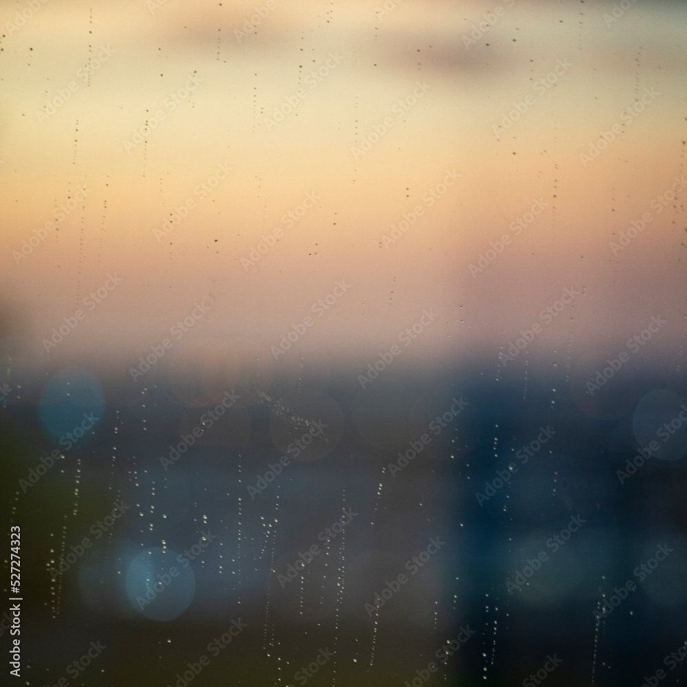 Rain droplets on window with out of focus background
