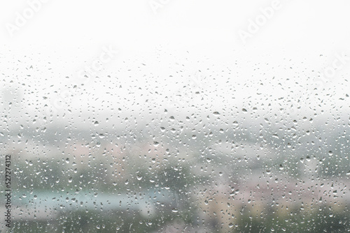 Rain droplets on window with out of focus background
