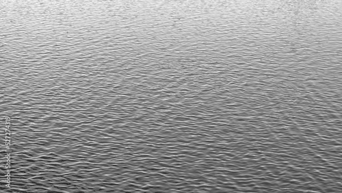 Water surface with ripples and sunlight reflections